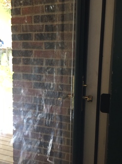 Smudges on a glass door left from children's handprints.