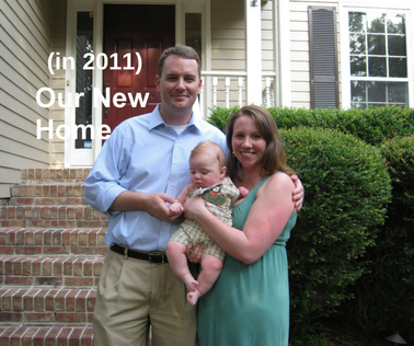 A couple standing in front of a house with their young son. Chantel and Marc Minish