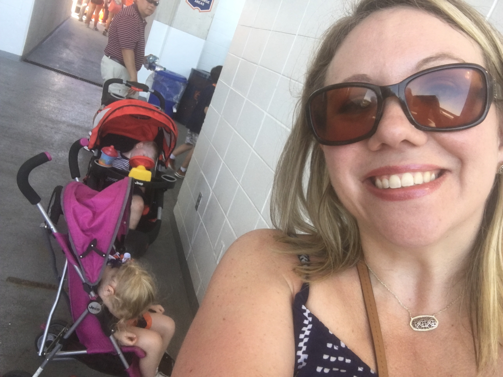 Picture of a mom with two sleeping children in strollers